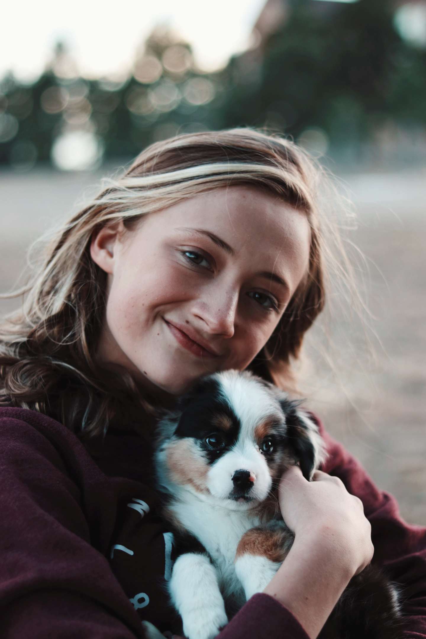 teenager hugging a puppy